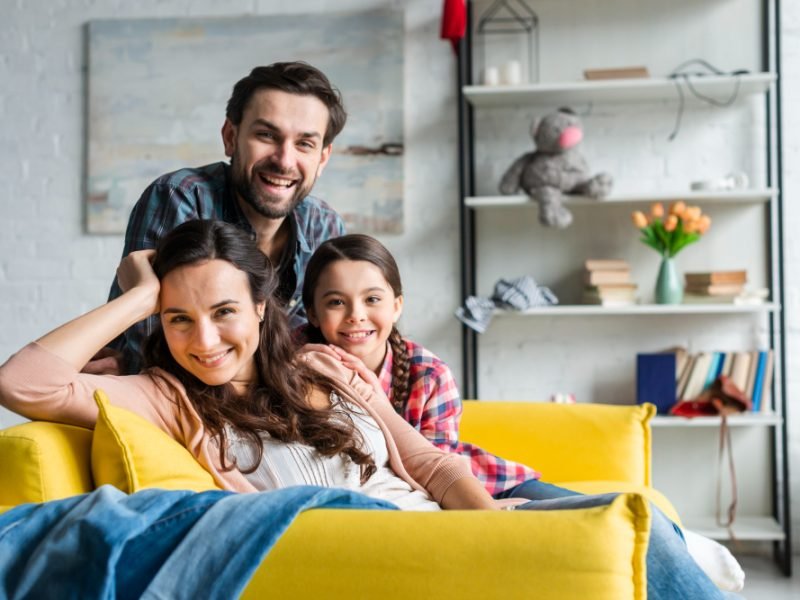 happy-family-sitting-on-couch-in-living-room (2)